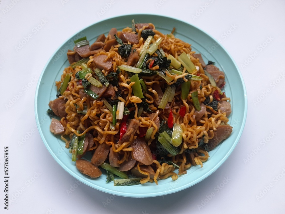 fried noodles with mixed mustard greens on a plate top view against a white background. healthy food background concept, food recipe, restaurant, breakfast, lunch, dinner, traditional food, lifestyle fried noodles with mixed mustard greens on a plate top view against a white background. healthy food background concept, food recipe, restaurant, breakfast, lunch, dinner, traditional food, lifestyle