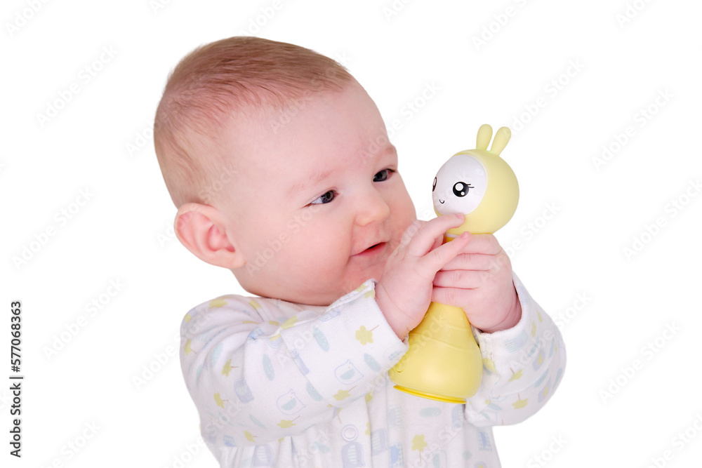 Smiling baby plays lying on the floor with toys, isolated on a white background. Four month old child on the white carpet holding a toy in his hands Smiling baby plays lying on the floor with toys, isolated on a white background. Four month old child on the white carpet holding a toy in his hands