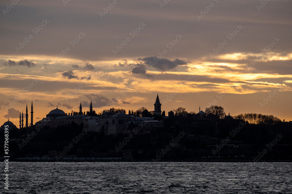 During the sunset historical peninsula and Topkapi Palace in Istanbul, Turkey. This picture was taken from the sea.