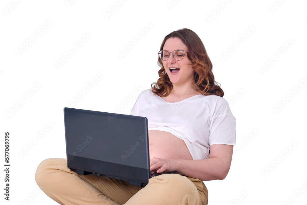 Workplace in a home bed with a computer and phone, laughing pregnant woman working on a laptop, isolated on a white background Workplace in a home bed with a computer and phone, laughing pregnant woman working on a laptop, isolated on a white background
