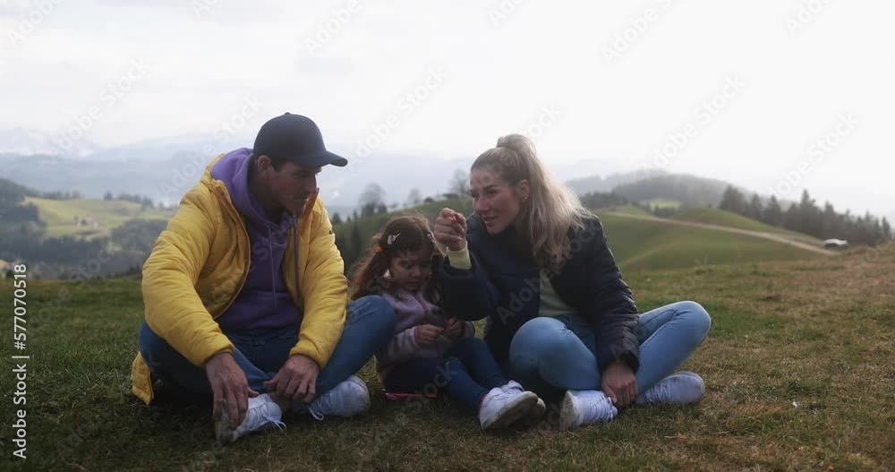 Happy young family having fun taking a break during hiking day in dolomites mountains