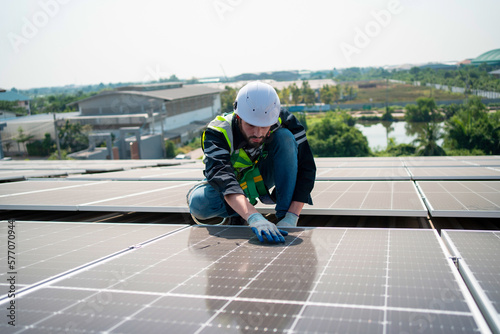Engineer working on checking and maintenance solar panel on rooftop.