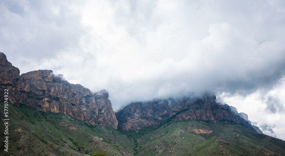 Foggy green mountains. Landscape in rainy day. Mountains of rural highland under cool cloudy sky in the summer rainy day. Low clouds.