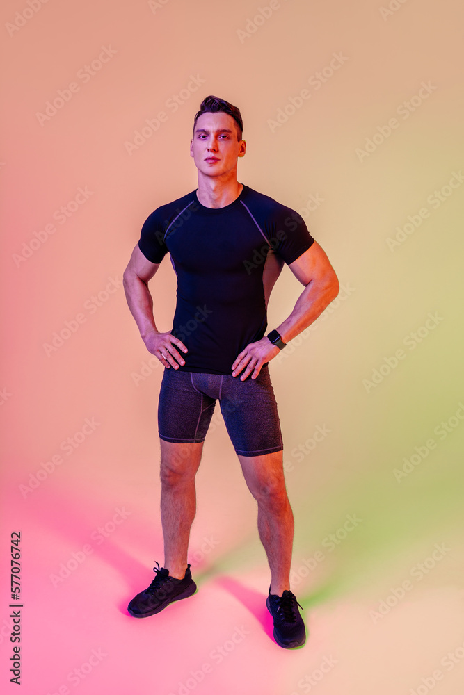 Athletic man with fit muscular body training in studio - Active man doing a workout, colorful lighting and background, concepts about fitness, sport and healthy lifestyle Athletic man with fit muscular body training in studio - Active man doing a workout, colorful lighting and background, concepts about fitness, sport and healthy lifestyle