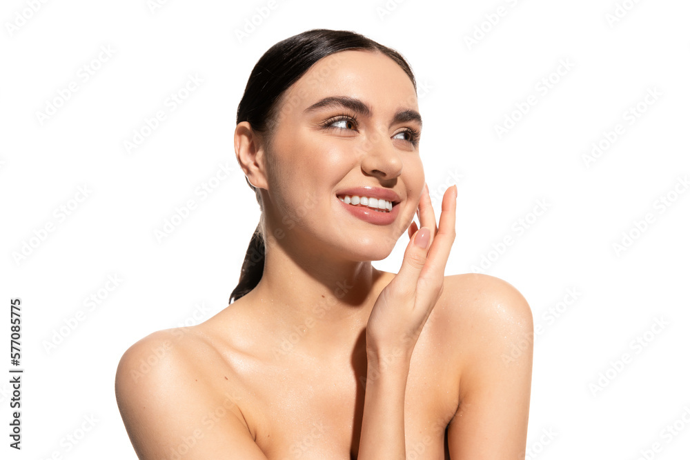 happy young woman with natural makeup and bare shoulders touching cheek isolated on white. happy young woman with natural makeup and bare shoulders touching cheek isolated on white.