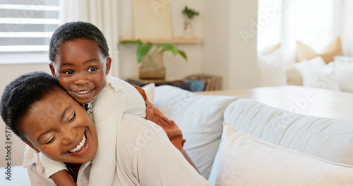 Love, mother and excited child hug playing together bonding in bedroom at house. Happy black woman and baby affection smile, trust and support care or enjoy spending quality time at family home