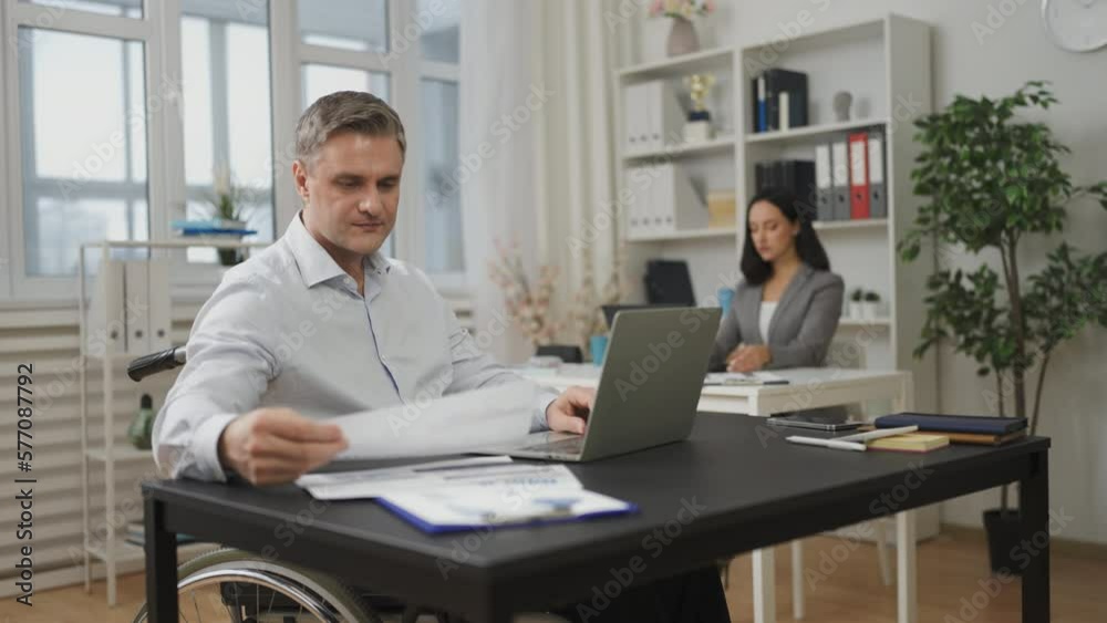 Middle-aged man with disability working in office, financial analyst, lifestyle Middle-aged man with disability working in office, financial analyst, lifestyle