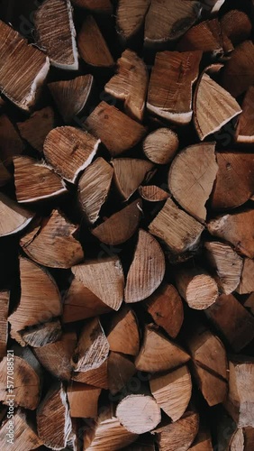 Chopped firewood is stacked in a big pile Slow motion Vertical video