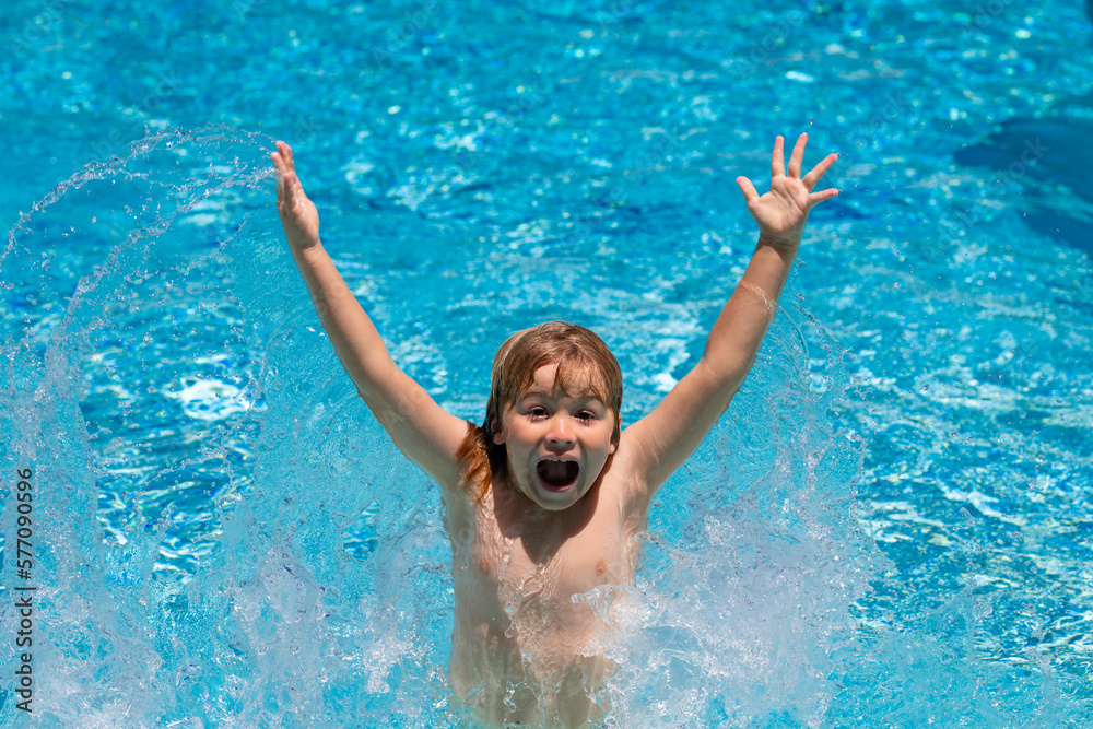 Funny excited little boy relaxing in a swimming pool, having fun during summer vacation in a tropical resort.