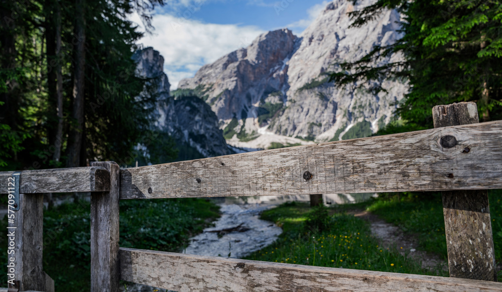 Close-up of an old wooden fence with a blurred image of mountains in the background.