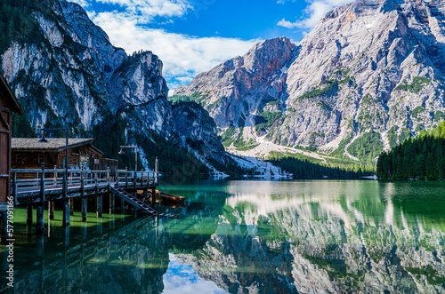 Fototapeta Naklejka Na Ścianę i Meble -  Lake surrounded by the mountains of the Italian alps. Fabulous views, magnificent mountains and lake. Free space for inscription text poster on backdrop nature Lake Braies emerald clear water.