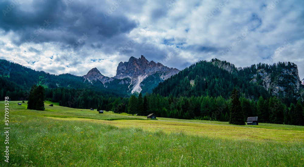 Spring in Alps. Image of the Italian Alps with mountain road, rural house and rocky mountains during spring rain. Colorful bright panorama of the Gardena Valley. Morning in the Dolomites, South Tyrol.