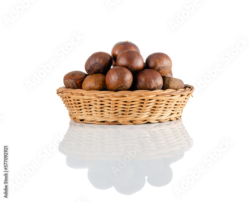 macro or close-up side view of chestnut in a wicker basket and reflection isolated on white background, Suitable for creative graphic design, clipping path.