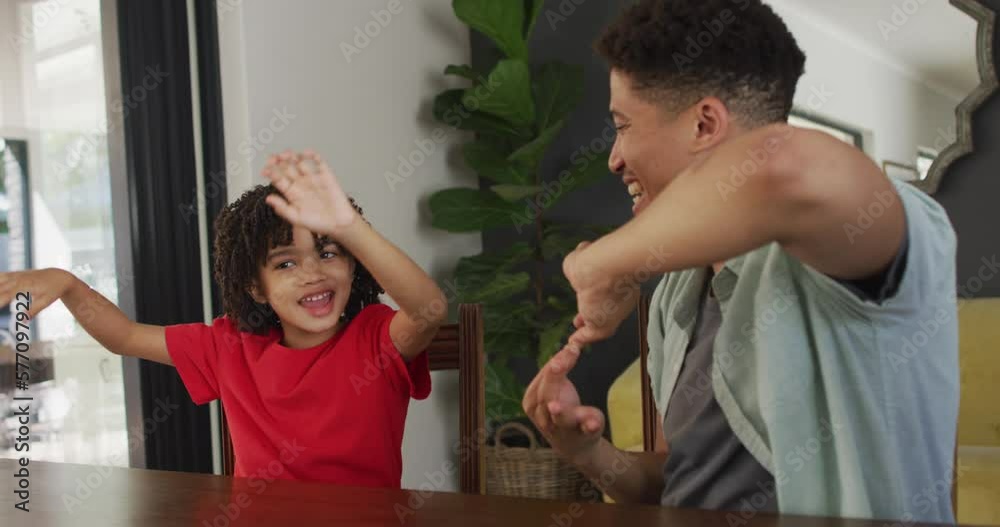 Happy biracial man and his son using sign language
