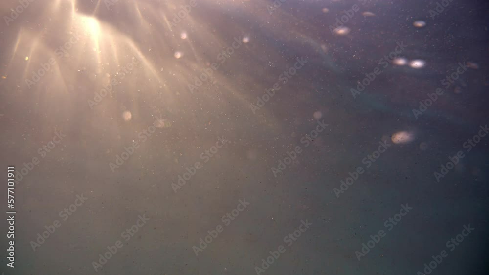 Camera below the surface of the water, the sun breaks through the water. We see the edge of the water, we go under the water. Sea surface at sunset. Camera below the surface of the water, the sun breaks through the water. We see the edge of the water, we go under the water. Sea surface at sunset.