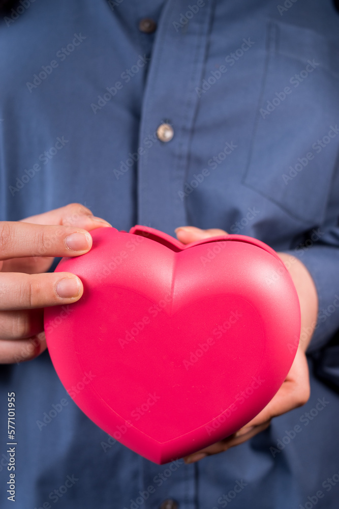 Office woman holding heart-shaped lunch container Office woman holding heart-shaped lunch container