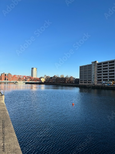 Modern buildings and landmarks next to the water with a blue sky background. Salford Quays England. 