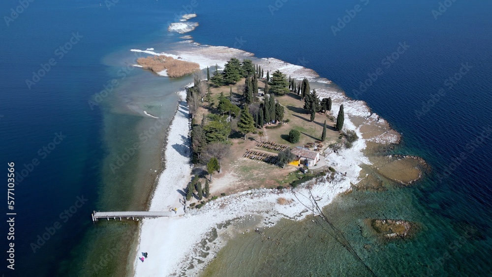 Italy, Lake Garda ,San Biagio Island , Rabbit Island - the shallow waters of the lake allow you to walk and reach the island on foot - water emergency in Lombardy , drought lowering of the water level
