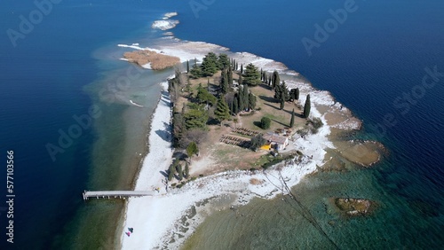 Obraz na płótnie Italy, Lake Garda ,San Biagio Island , Rabbit Island - the shallow waters of the lake allow you to walk and reach the island on foot - water emergency in Lombardy , drought lowering of the water level w salonie