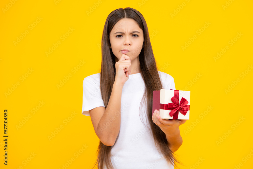 Teenager kid with present box. Teen girl giving birthday gift. Present, greeting and gifting concept. Thinking face, thoughtful emotions of teenager girl. Teenager kid with present box. Teen girl giving birthday gift. Present, greeting and gifting concept. Thinking face, thoughtful emotions of teenager girl.