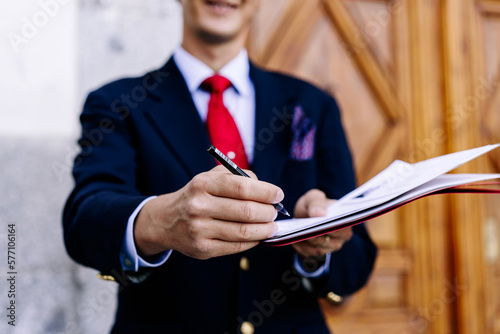 Crop businessman offering to sign document