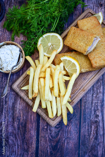   Allasca Pollock Fish  Bites in a crispy Tempura  Batter.Fish and chips .Close up of   crispy breaded  deep fried fish fingers with breadcrumbs s erved with remoulade sauce and  lemon photo