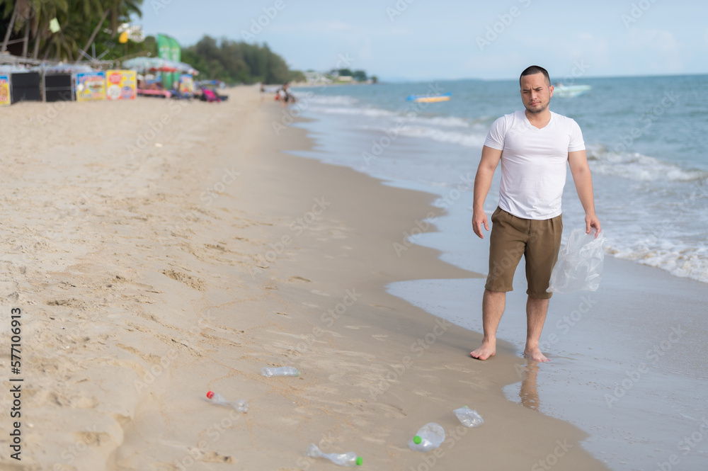 Asian man keep garbage at inside sea beach,people volunteer keeping garbage plastic bottle