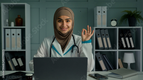 Canvas Print Glad happy arabian middle-eastern doctor young islamic religion woman practition
