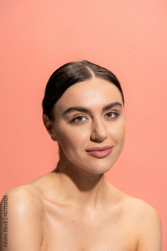 young brunette woman with brown eyes and bare shoulders looking at camera isolated on pink. young brunette woman with brown eyes and bare shoulders looking at camera isolated on pink.