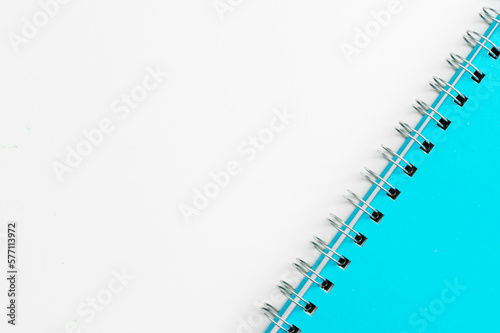 Close-up of a blue notebook with checkered pages. Spiral notebook isolated