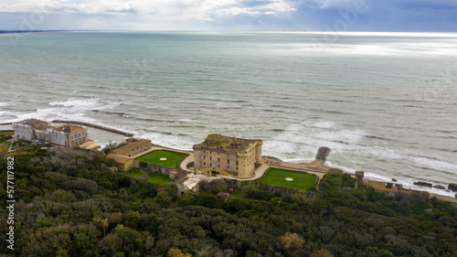 Aerial view of the Odescalchi Castle of Ladispoli, located in the Metropolitan City of Rome, Italy. This medieval castle is built on the sea and has a large garden.
