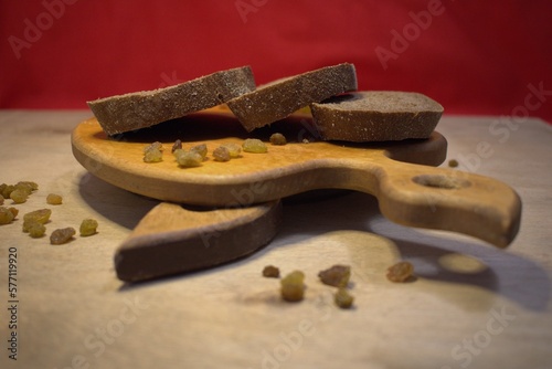 chopped bread on the board on a wooden background with a shade of red