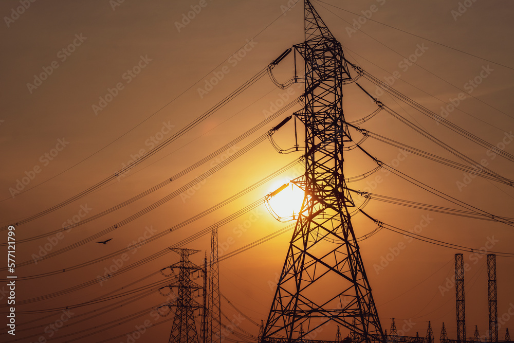 high voltage electricity python and transmission line, power and energy at sunset