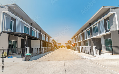 The rows of new townhouses, view of the houses with paved roads in the middle , the architectural design of the exterior, The concept for Sale, Rent, Housing, and Real Estate