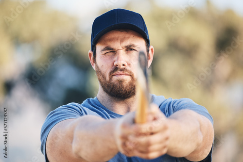 Target, focus and axe throwing with man in nature and aim for sports, training and tomahawk skills. Exercise, goal and hunting with athlete and hatchet in range for bullseye, ready and competition photo
