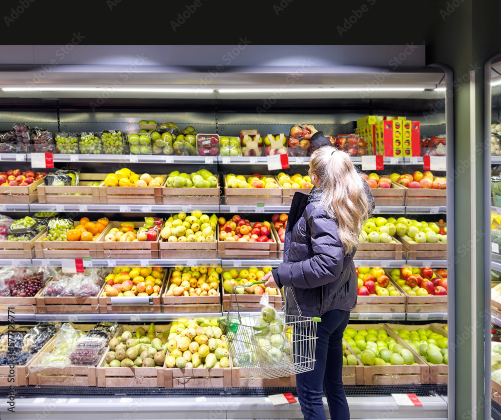 Woman buying fruits and vegetables at the market