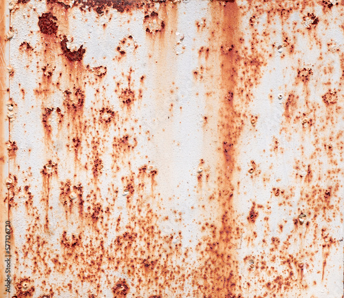 Corroded metal background. Rusted grey painted metal wall. Rusty metal background with streaks of rust. Rust stains. The metal surface rusted spots. Rystycorrosion. 