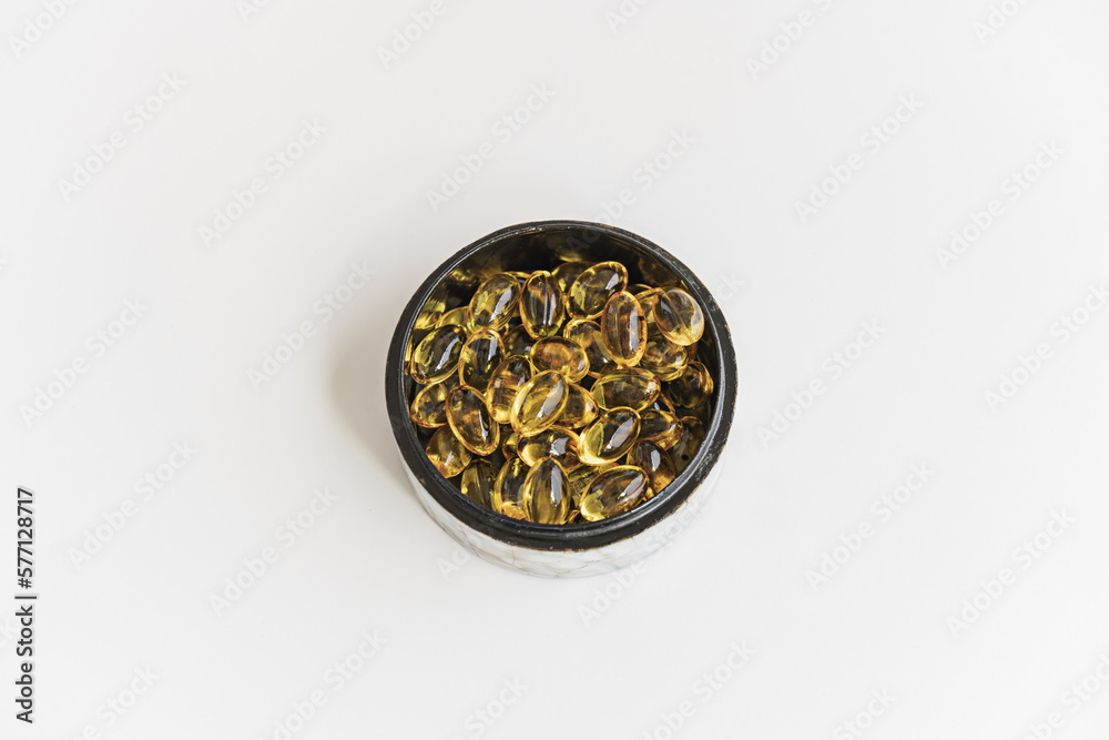 A round mother-of-pearl box with a black interior filled with pearls of a supreme liquid dietetic