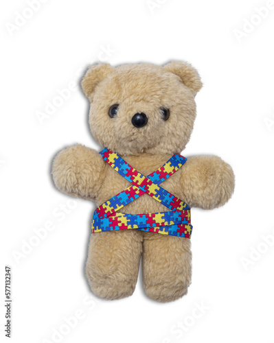 World Autism Awareness day, mental health care concept with teddy bear and ribbon puzzle pattern. On white background.