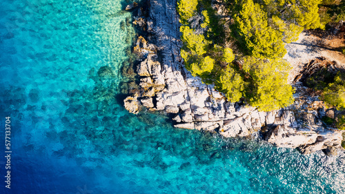 The stunning beauty of Croatia's rocks and forests is captured in this breathtaking aerial view. Take in the turquoise waters and beach from above, and add this travel image to your collection of unfo