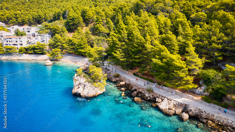 Enjoy the view of Croatia's beach from above, where turquoise waters meet soft sands. Relax and find adventure in this beautiful vacation spot, captured in stunning aerial photography.