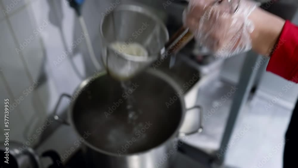cooking rice in kitchen of pan-asian restaurant, cook putting rice in boiling water, tasty food cooking rice in kitchen of pan-asian restaurant, cook putting rice in boiling water, tasty food