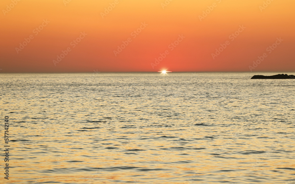 Sunset, ocean and horizon with a view over the sea during summer under an orange sky for mockup. Nature, water and earth with waves on a seascape for zen, peace or inspiration on a sunrise backdrop