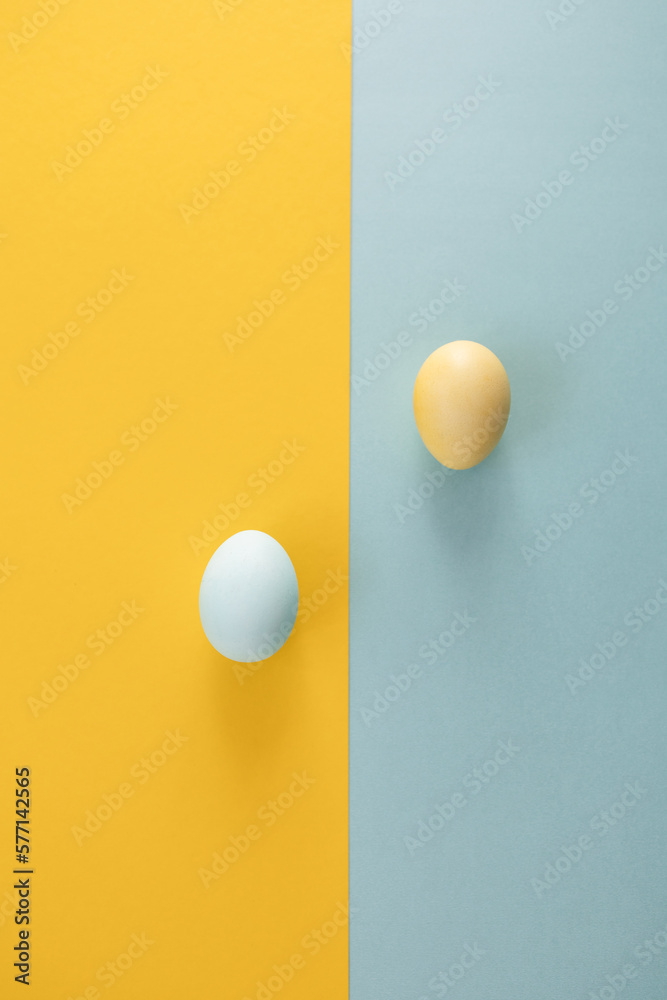 Eggs on a yellow and light blue background. Easter decor. Yellow and blue color