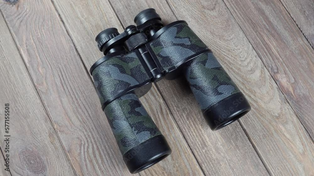 Rotating Retro Binoculars From Above On The Background. Rotating Retro Binoculars From Above On The Background.