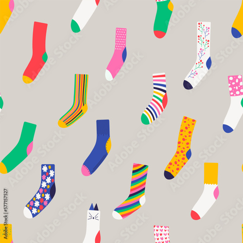 Seamless pattern with colorful trendy socks. Wool, cotton warm accessories with modern patterns. Unisex clothes. Flat style vector illustration