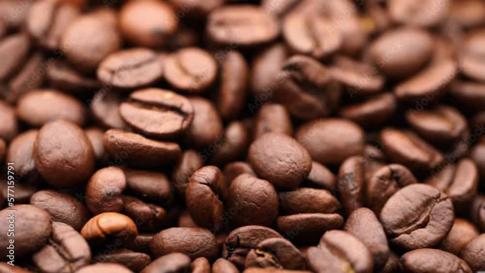 Roasting coffee beans. Slow rotation of coffee beans. Texture of coffee. Invigorating drink. Roasting coffee beans. Slow rotation of coffee beans. Texture of coffee. Invigorating drink.