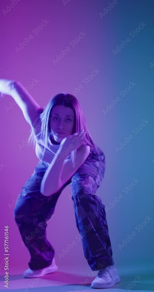 Lady clubbing at disco party with colorful flashes of light on dark background. Girl dancing hip hop slow motion vertical video. Lady clubbing at disco party with colorful flashes of light on dark background. Girl dancing hip hop slow motion vertical video.