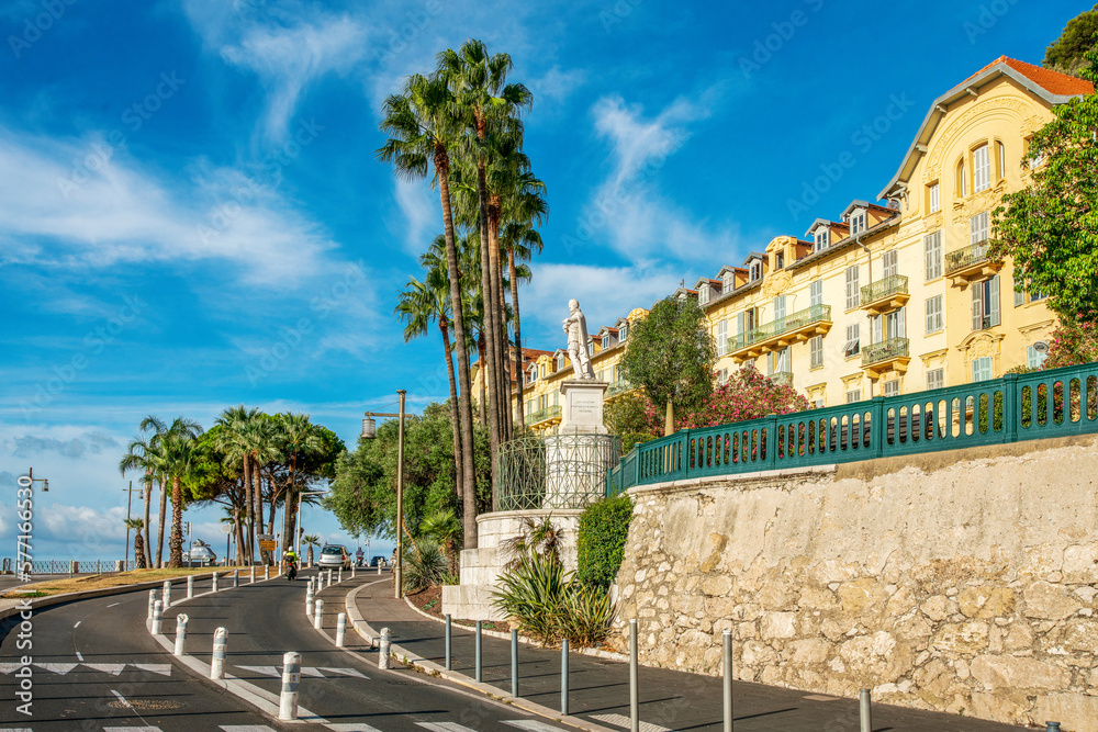Amazing  embankment of port Lympia in Nice  with tall palms and cars. residential building.