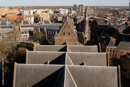 Groningen cityscape skyline horizon on a sunny clear day. The Martinikerk St martins church gothic religious architecture roof in foreground is prominent against modern buildings photo